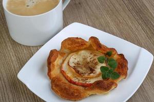 Apple pastry on the plate and wooden background photo