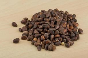 Cedar nut on wooden background photo