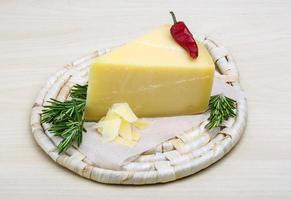 Parmesan cheese on wooden board and white background photo