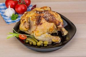 Grilled chicken on the plate and wooden background photo