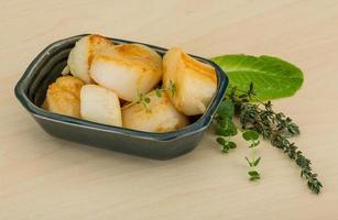 Grilled scallops in a bowl on wooden background photo