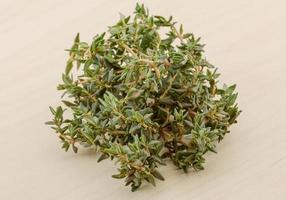 Thyme on wooden background photo