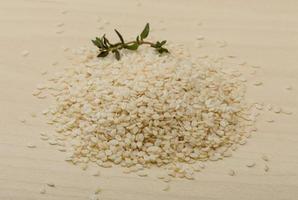 Sesame seeds on wooden background photo