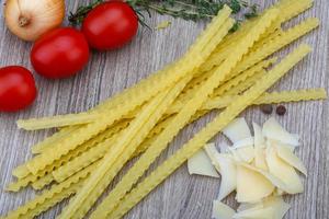 Mafalde pasta on wooden background photo