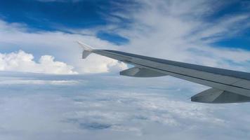 Airplane window view on blue sky and beautiful white clouds. Concept airplane travel video