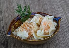 Shrimp wanton in a bowl on wooden background photo