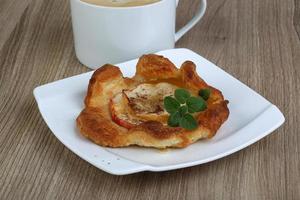 Apple pastry on the plate and wooden background photo