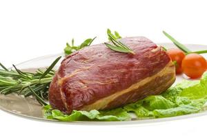 Smoked beef on the plate and white background photo