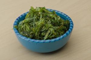 Chuka salad in a bowl on wooden background photo