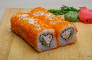 California roll on wooden board and wooden background photo