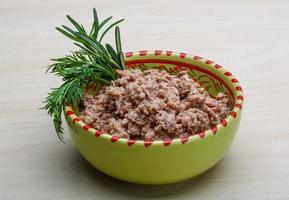 Cannded tuna in a bowl on wooden background photo