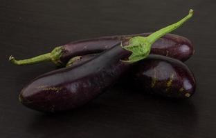 Aubergine on wooden background photo