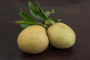 Sapodilla on wooden background photo