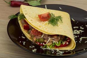 Tuna tortilla on the plate and wooden background photo