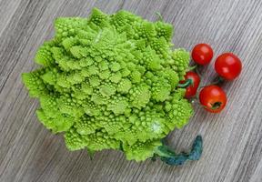 Romanesco cabbage on wooden background photo