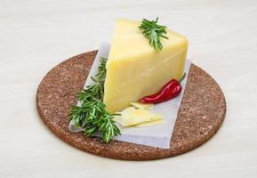 Parmesan cheese on wooden board and white background photo