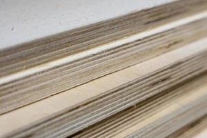 a stack of thick sheets of wooden plywood in a hardware store photo