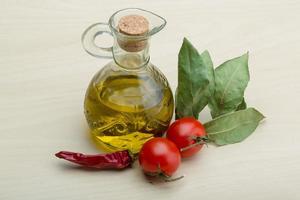 Olive oil on wooden background photo