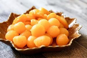 Thai Desserts   Drops of gold and Jackfruit seed on leaf-shaped plates. photo