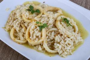 Squid risotto on the plate photo