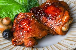Teriyaki chicken on the plate and wooden background photo