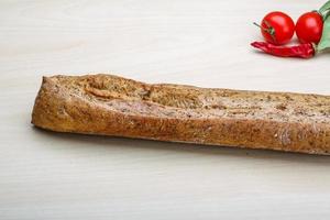 Baguette on wooden background photo