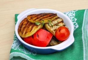 Grilled vegetables in a bowl on wooden background photo