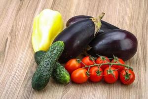 Fresh vegetables on wooden background photo