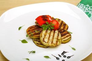 Grilled vegetables on the plate and wooden background photo
