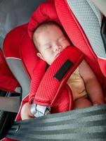Newborn baby girl sleep in car seat photo
