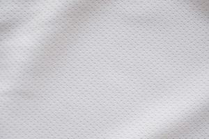 White fabric sport clothing football jersey with air mesh texture background photo