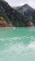 Boat view of Alaskan lake and forested mountains video