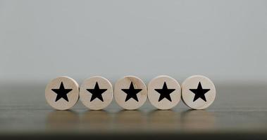 Satisfaction survey concept. Customer services best excellent business rating experience. Hand of business chooses a smile face on wood block circle. 5 Star Satisfaction. People feel great product. photo