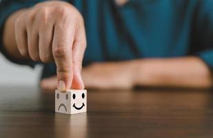 Satisfaction survey concept. Customer services best excellent business rating experience. Hand of business chooses a smile face on wood block circle. 5 Star Satisfaction. People feel great product. photo