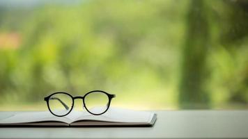 Object education green nature background with stack of ancient books or old bible, open paper book on wooden table with copy space. concept of back to school, research study photo