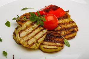 Grilled vegetables on the plate and wooden background photo