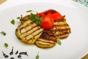 Grilled vegetables on the plate and wooden background photo