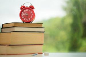 Object education green nature background with stack of ancient books or old bible, open paper book on wooden table with copy space. concept of back to school, research study photo