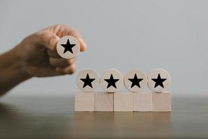Satisfaction survey concept. Customer services best excellent business rating experience. Hand of business chooses a smile face on wood block circle. 5 Star Satisfaction. People feel great product. photo