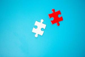 White part of jigsaw puzzle pieces on blue background. concepts of problem solving, business success, teamwork, Team playing jigsaw game incomplete, Texture photo with copy space for text