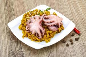 Seafood risotto on the plate and wooden background photo