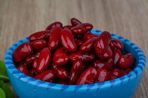Kidney beans in a bowl on wooden background photo