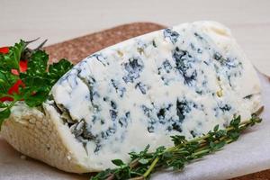 Blue cheese on wooden board and wooden background photo