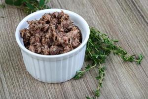 Canned tuna in a bowl on wooden background photo