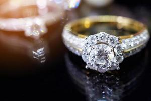 anillos de diamantes de joyería con una reflexión sobre fondo negro foto
