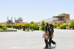 Isfahan, Iran,2022 - iranian woman walk together with hijabs on photo