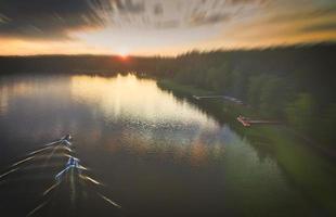 Aerial top down view of lake Baltieji Lakajai coast with boats and forest in Labanoras regional park, Moletai, Lithuania photo