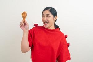 Asian woman with fried chicken on hand photo