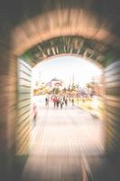 Tourists walk be entrance gates down the path towards national museum of Hagia Sophia. Concept of post pandemic tourism opening. Intentional motion blur tourism in Turkey photo