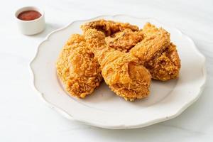 fried chicken with ketchup on plate photo